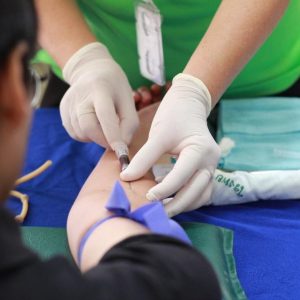  A person getting their blood drawn by a nurse