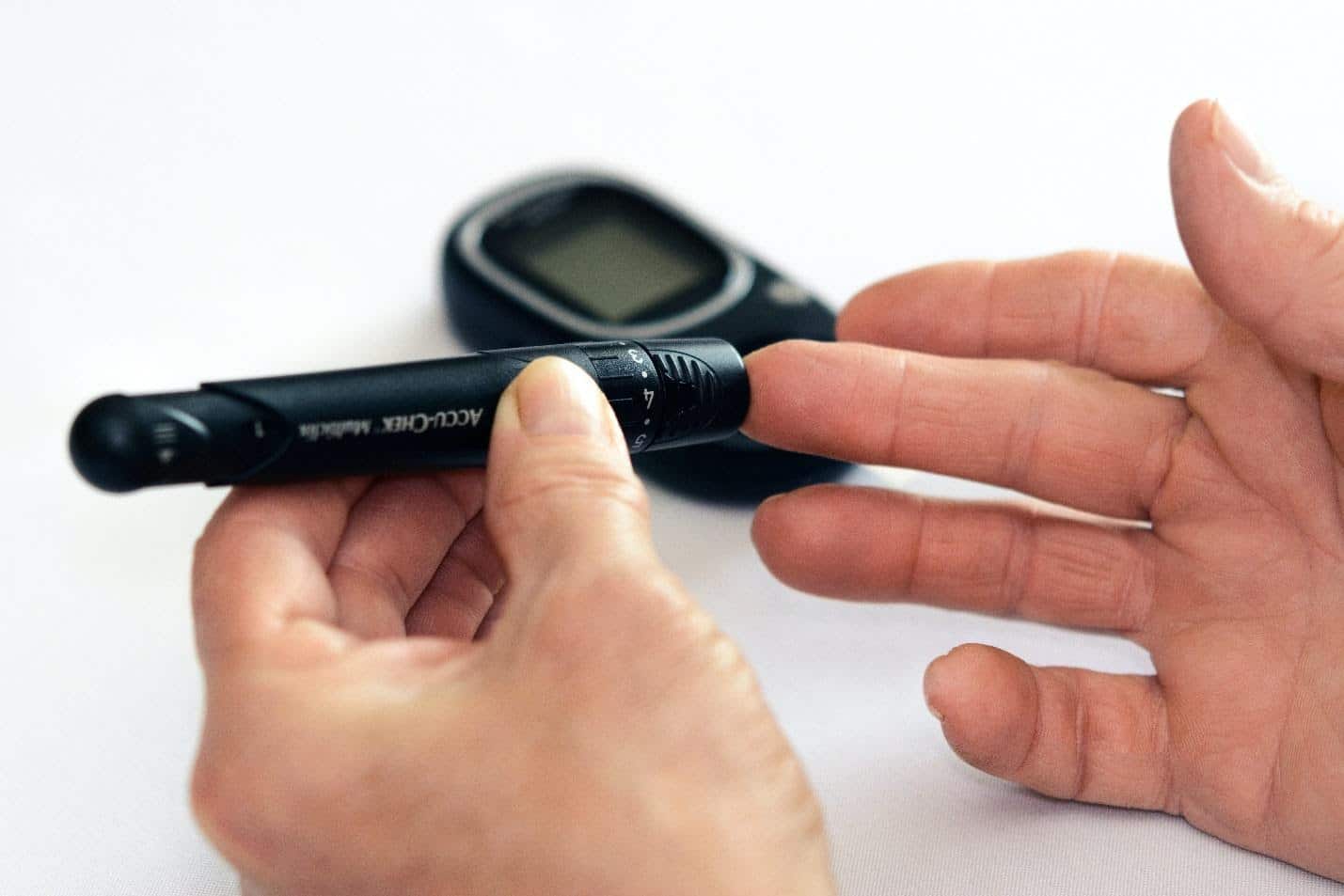 A person using a blood sugar test kit