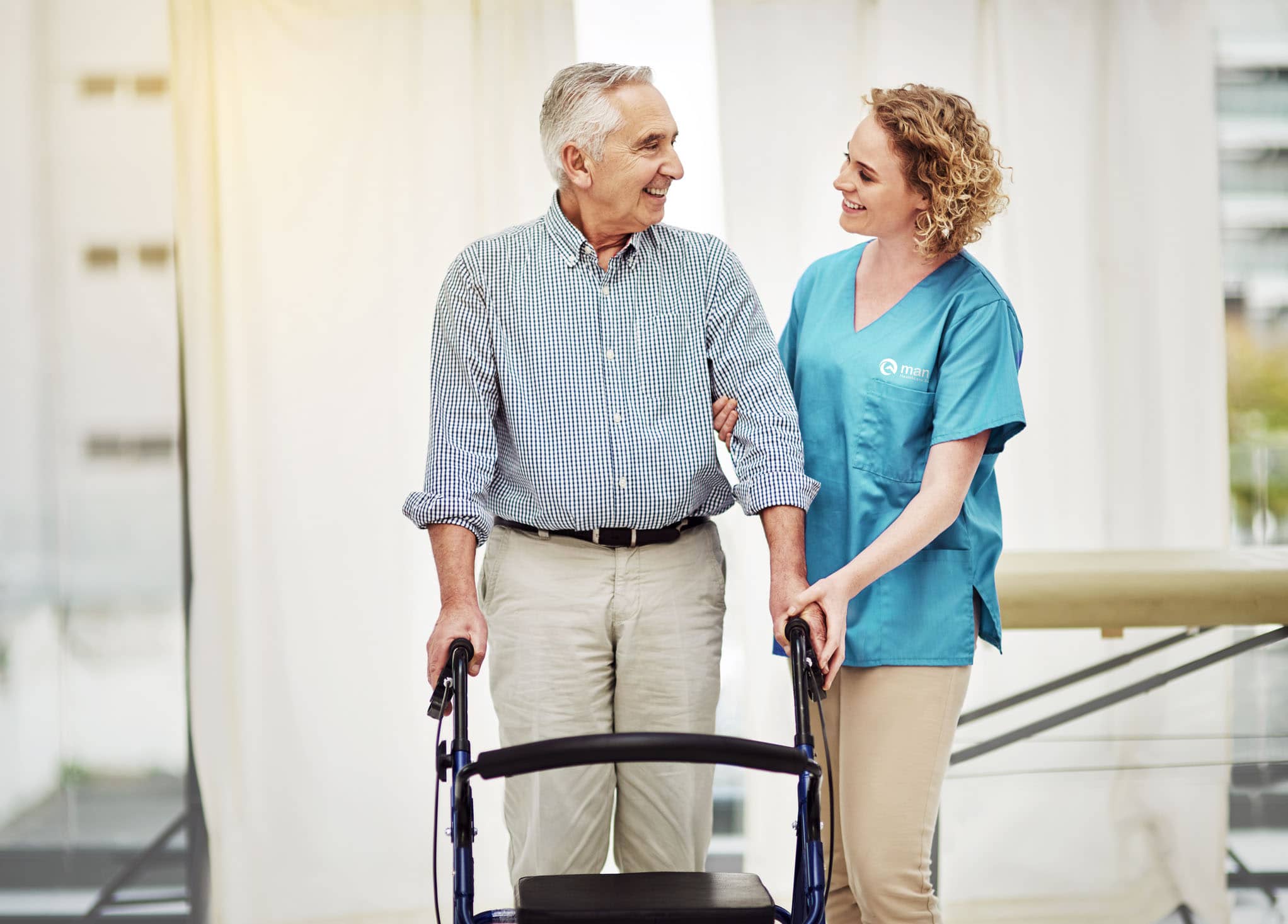 nurse assisting patient in a walker