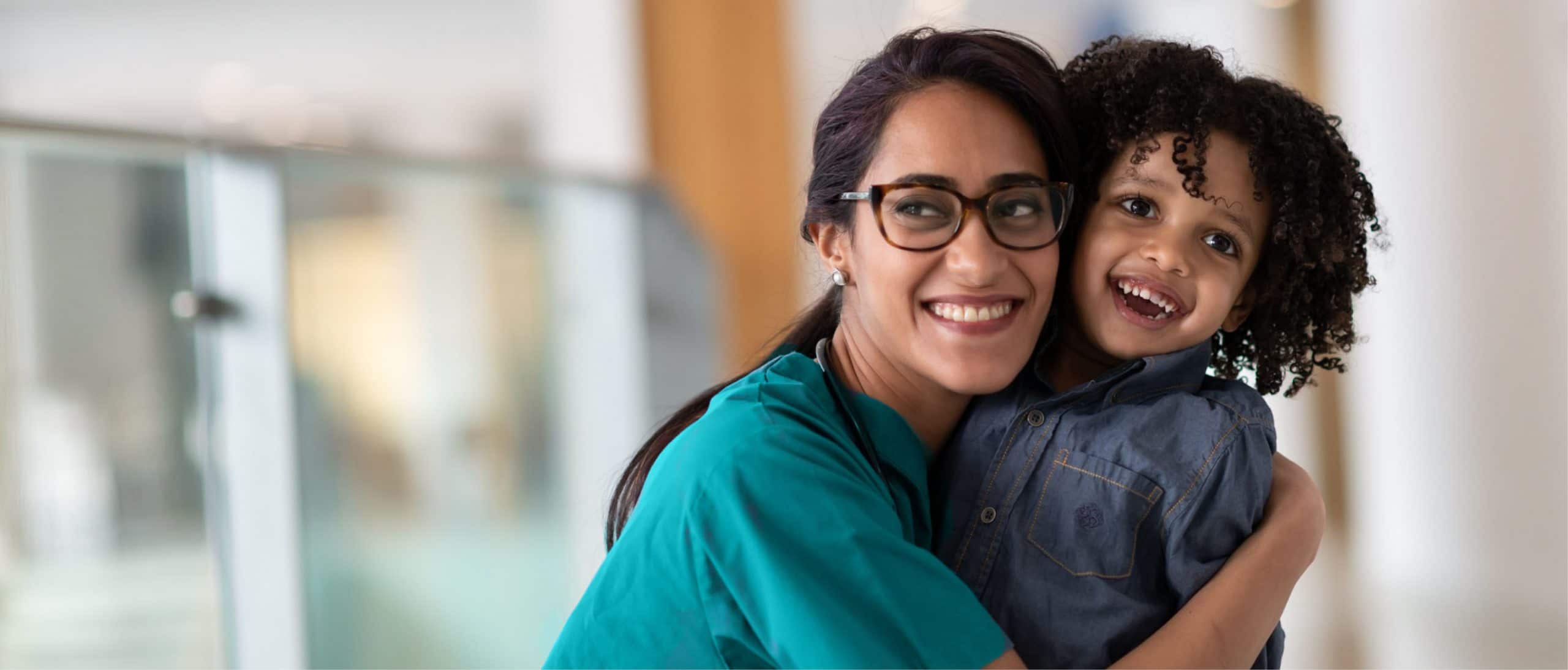 Manzil nurse hugging a child