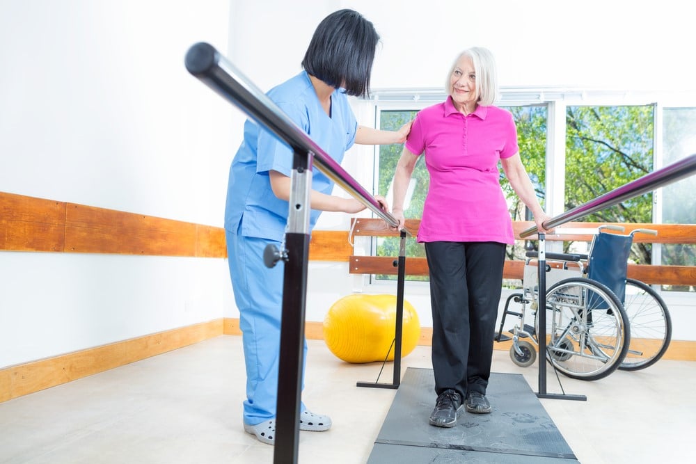 physiotherapist assisting patient during a therapy session